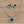 Load image into Gallery viewer, Teal heart necklace and clip-on earrings on pale barn wood
