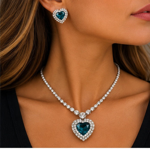Teal heart necklace and earrings styled on model