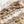 Load image into Gallery viewer, Silver hoop earrings with spike details on a natural stone surface with shells and driftwood.
