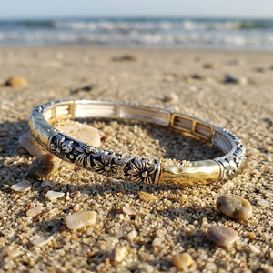 Decorative bracelet on a sandy beach with ocean in the background