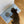 Load image into Gallery viewer, Dog standing on a blue and white striped rug with 'unikook' branding on a wooden floor.
