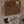 Load image into Gallery viewer, Brown diaper bag with a sheep toy on a bed, with a person partially visible.
