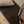 Load image into Gallery viewer, Person folding a piece of fabric on a wooden surface
