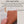 Load image into Gallery viewer, Vegan leather mat held by a hand with text about its properties and ethics.
