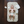 Load image into Gallery viewer, Baby lying on a quilted mat with diaper changing supplies on a wooden floor.
