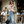 Load image into Gallery viewer, Woman in a trench coat and jeans walking on a street with a blurred background
