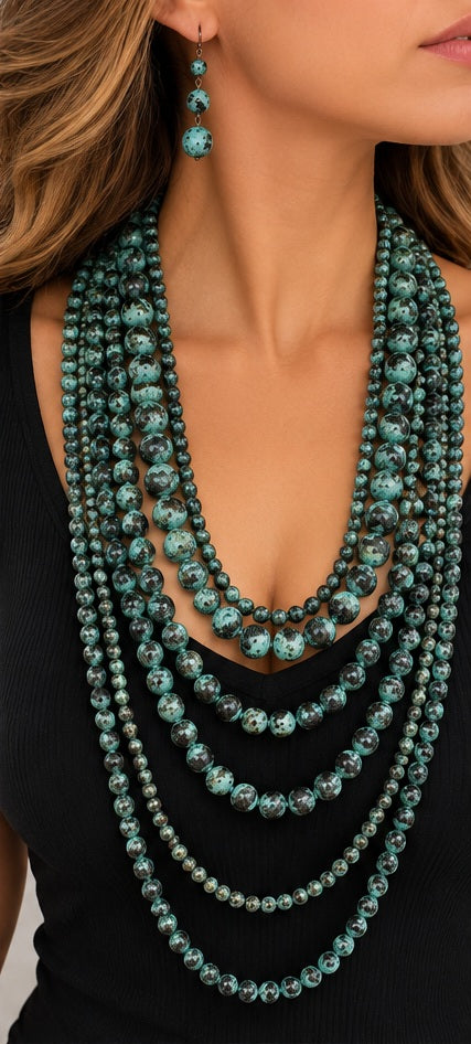 Long layered turquoise patina bead necklace and earrings worn with black top