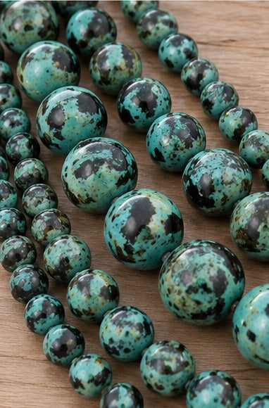 Close-up turquoise green dark marbled round beads