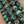 Load image into Gallery viewer, Close-up mottled turquoise green bead texture
