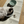 Load image into Gallery viewer, Cat eating from a bowl on a 'unikook' branded mat with a water bowl in the background.
