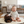 Load image into Gallery viewer, Baby sitting on a mat with a dog, both smiling, in a living room setting.
