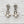 Load image into Gallery viewer, Pair of pearl and crystal earrings on a light wooden surface
