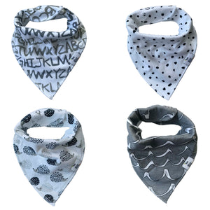 Four organic cotton baby bandana bibs in a set, featuring different patterns such as letters, dots, leaves, and stripes.